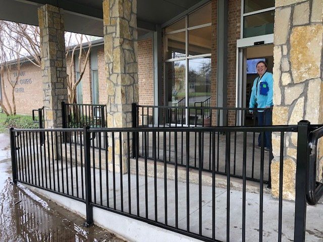 A man is standing in front of a building with a ramp.