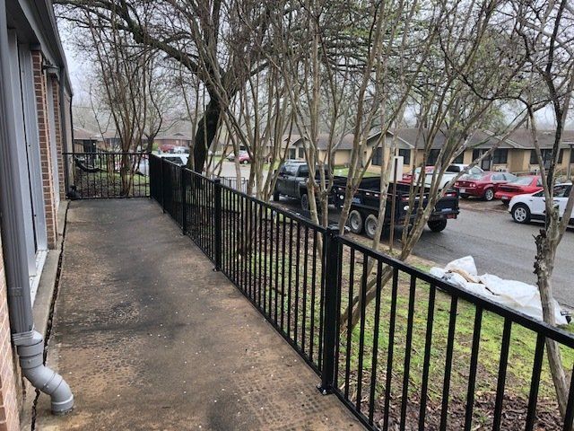 A black railing along the side of a house