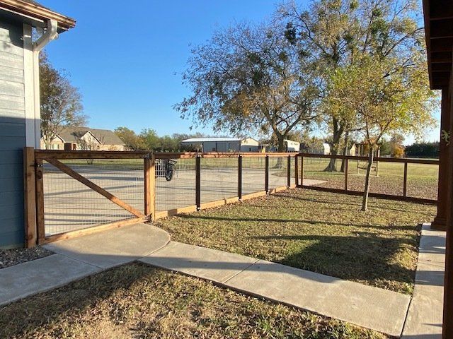 There is a wooden fence in the backyard of a house.