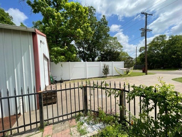 A white building with a black fence in front of it