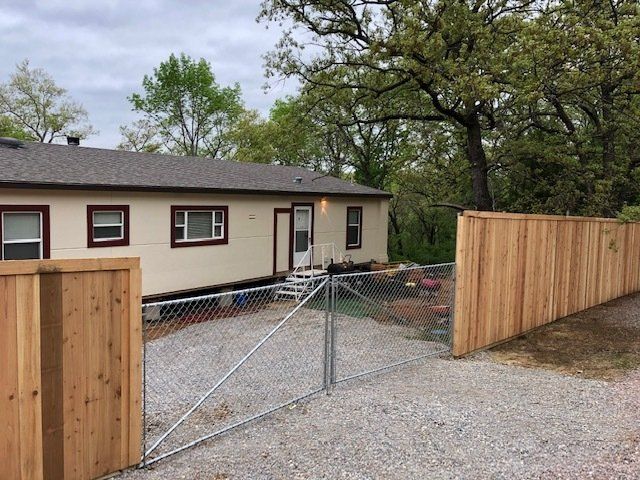 A mobile home with a wooden fence around it