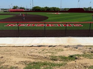 A baseball field with a fence that says ' texas rangers ' on it