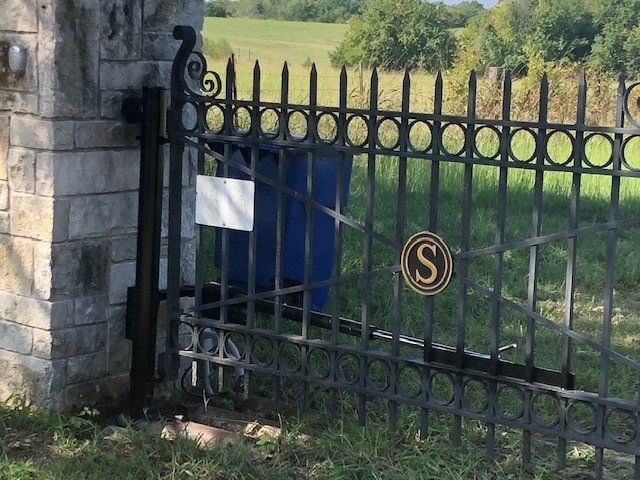 A wrought iron gate with the letter s on it