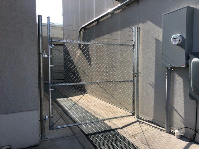 A chain link fence with a gate in the middle of it