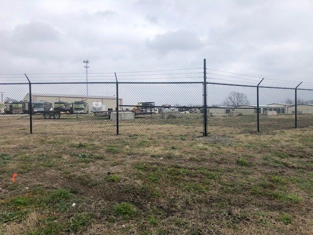 There is a fence in the middle of a field.