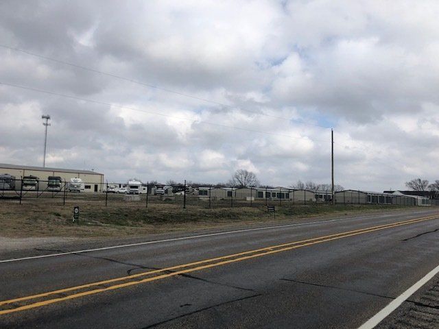 A road with a lot of trailers parked on the side of it