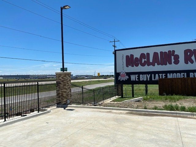 A sign for mcclain 's rv says we buy late model rvs