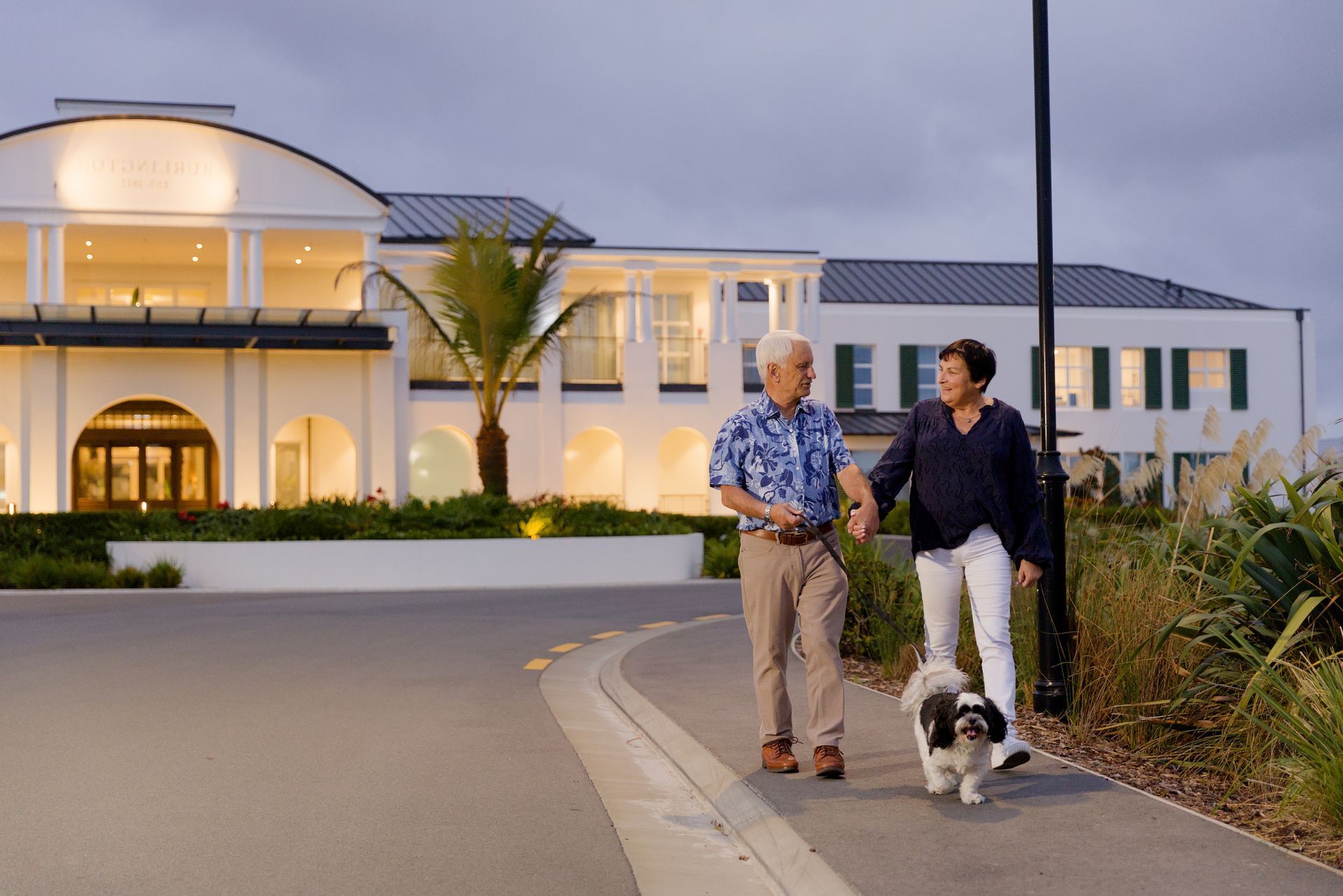 Couple walking with dog at Burlington village