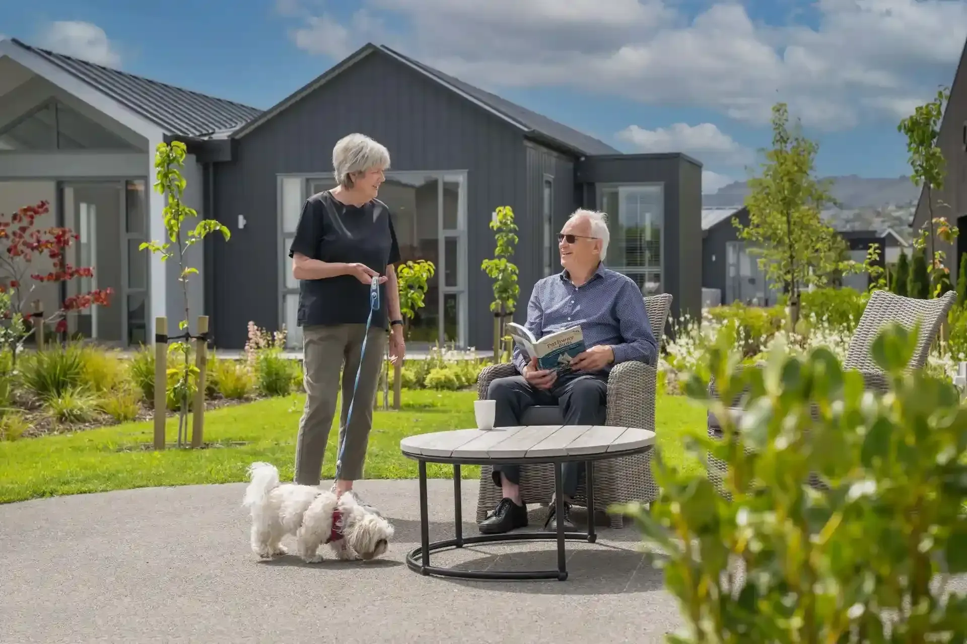Residents relaxing in garden with dog