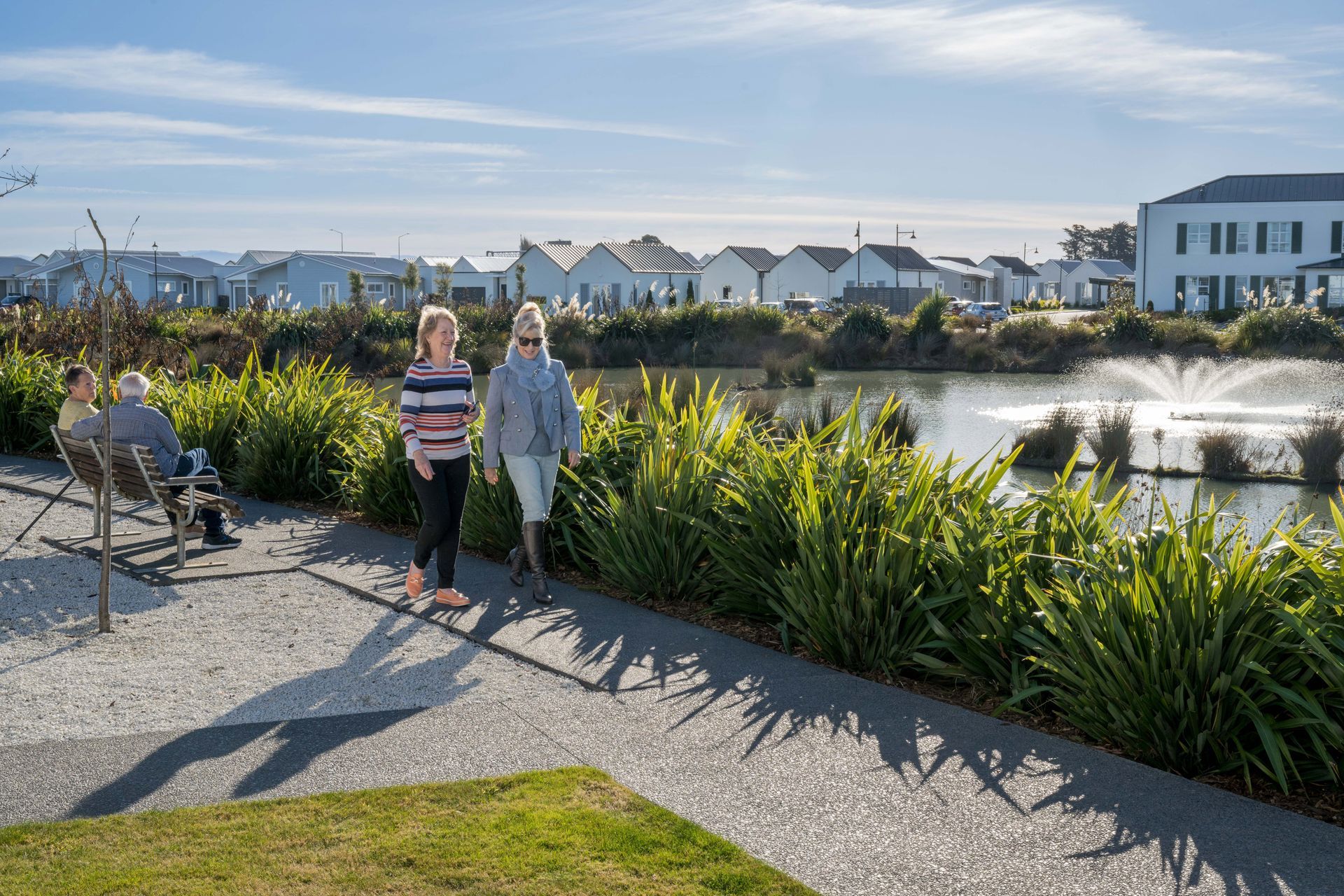 Residents walking by village lake