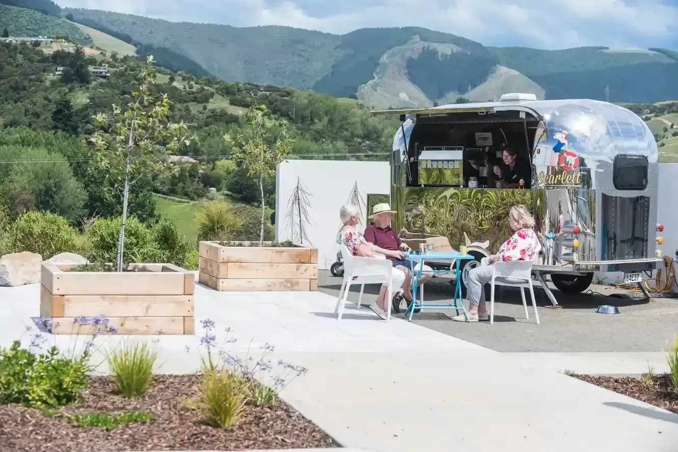 Residents relaxing by café truck