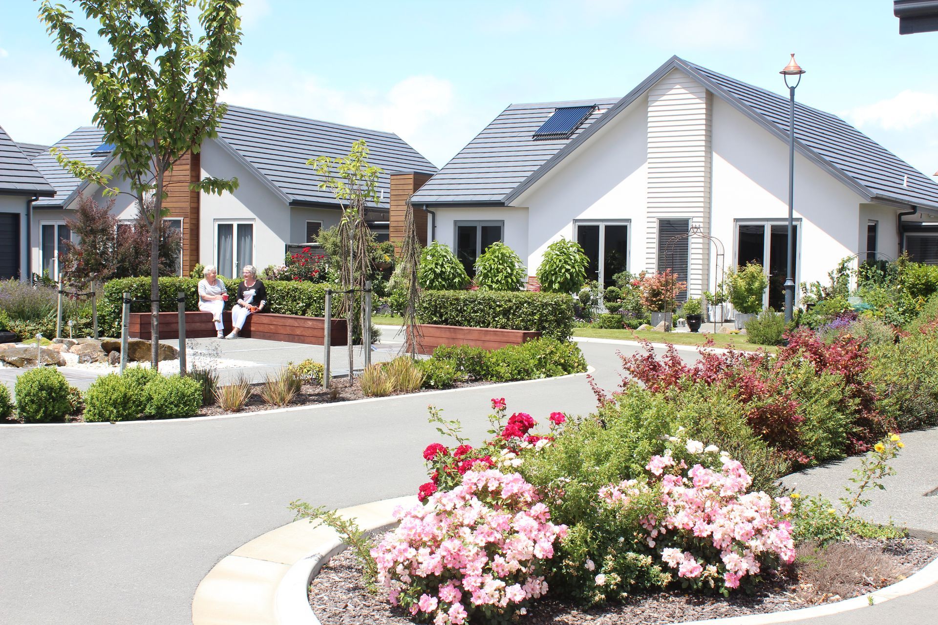 Residents relaxing in landscaped courtyard