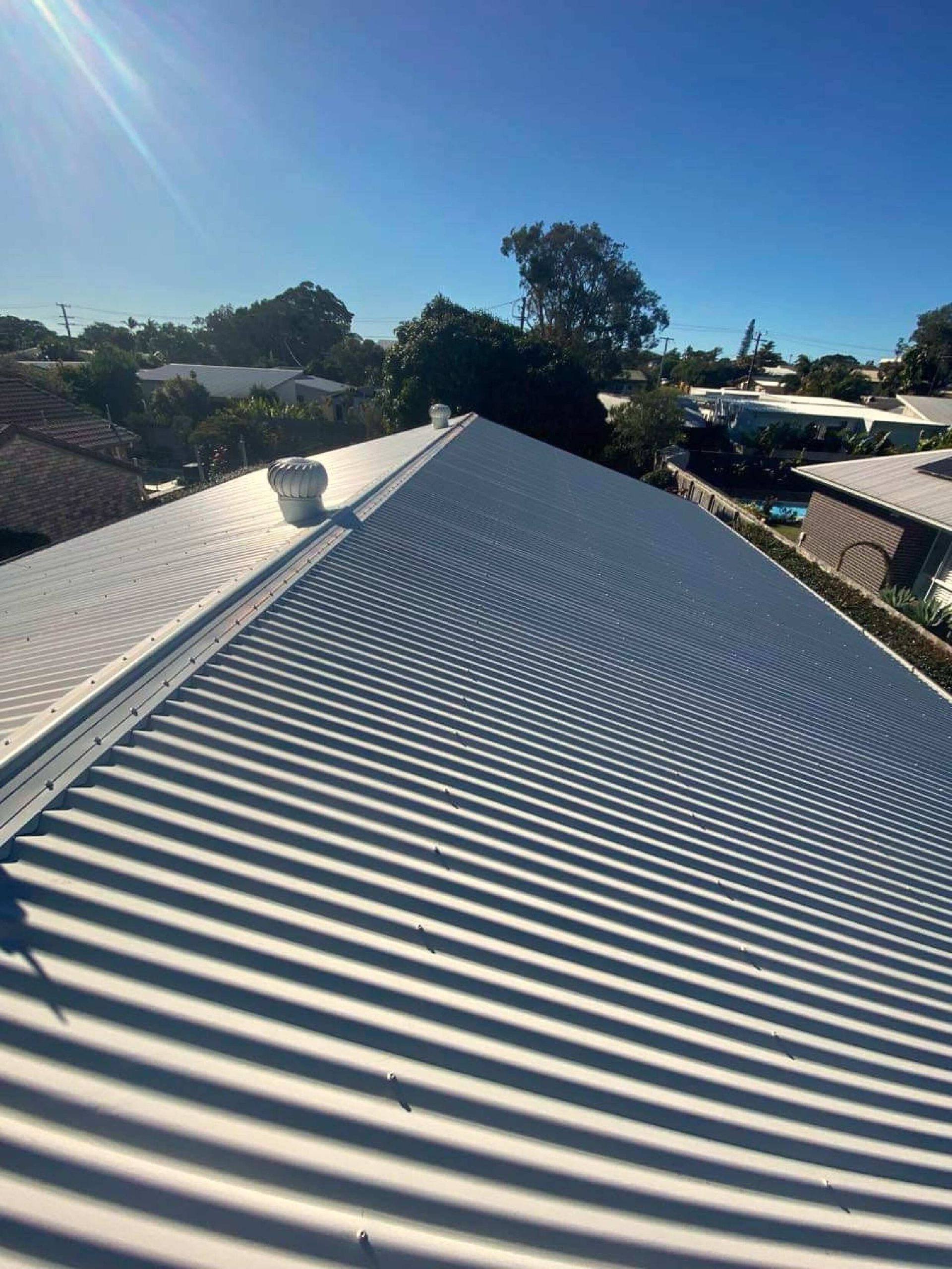 A Close Up Of A Tiled Roof With A Blue Sky In The Background — Coastal Roof & Gutter Services In Coolum Beach, QLD