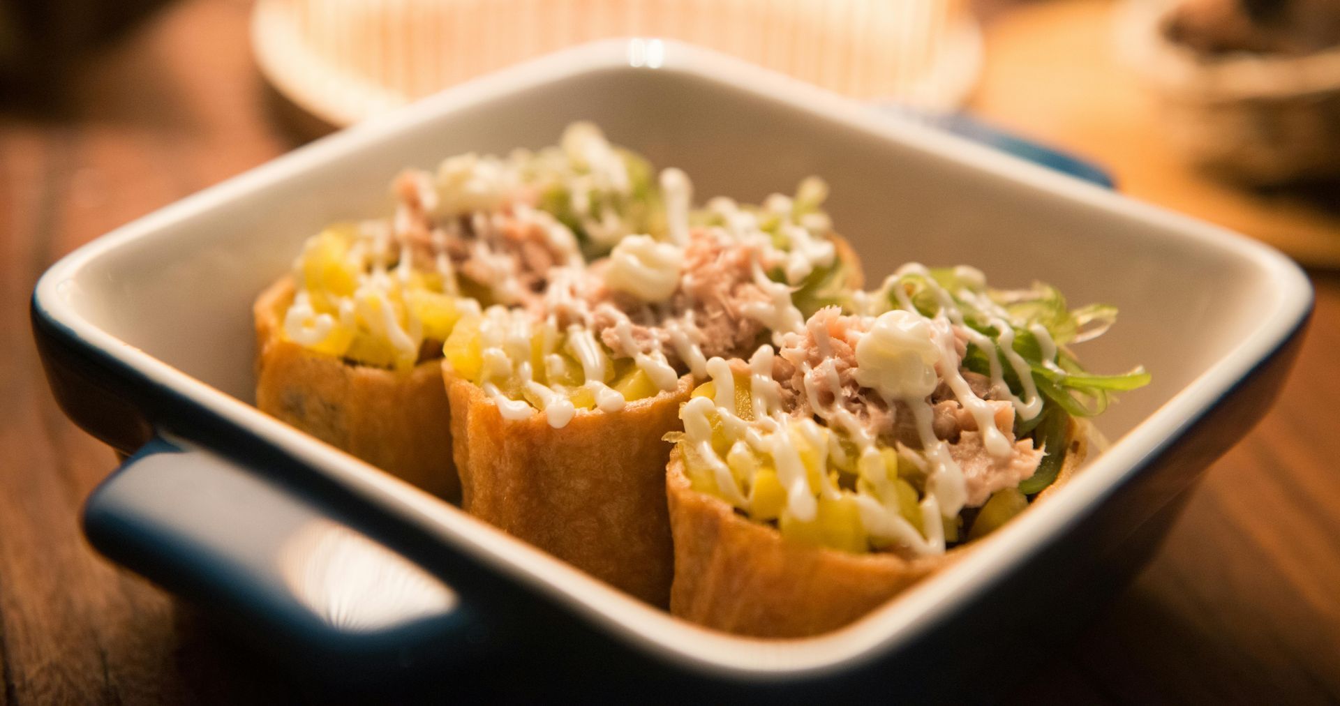 A casserole dish filled with food on a wooden table.