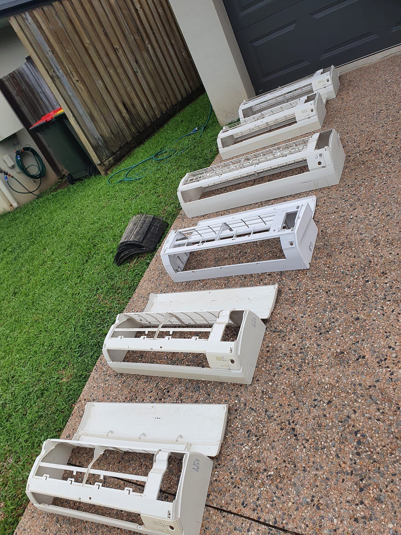 An Air Conditioner Parts Laid out On a Concrete Walkway — Coach That Cleans in Woree, QLD