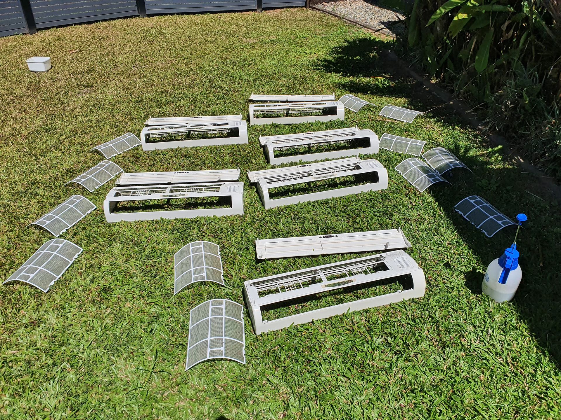 An Air Conditioner Parts Drying on Grass — Coach That Cleans in Stratford, QLD