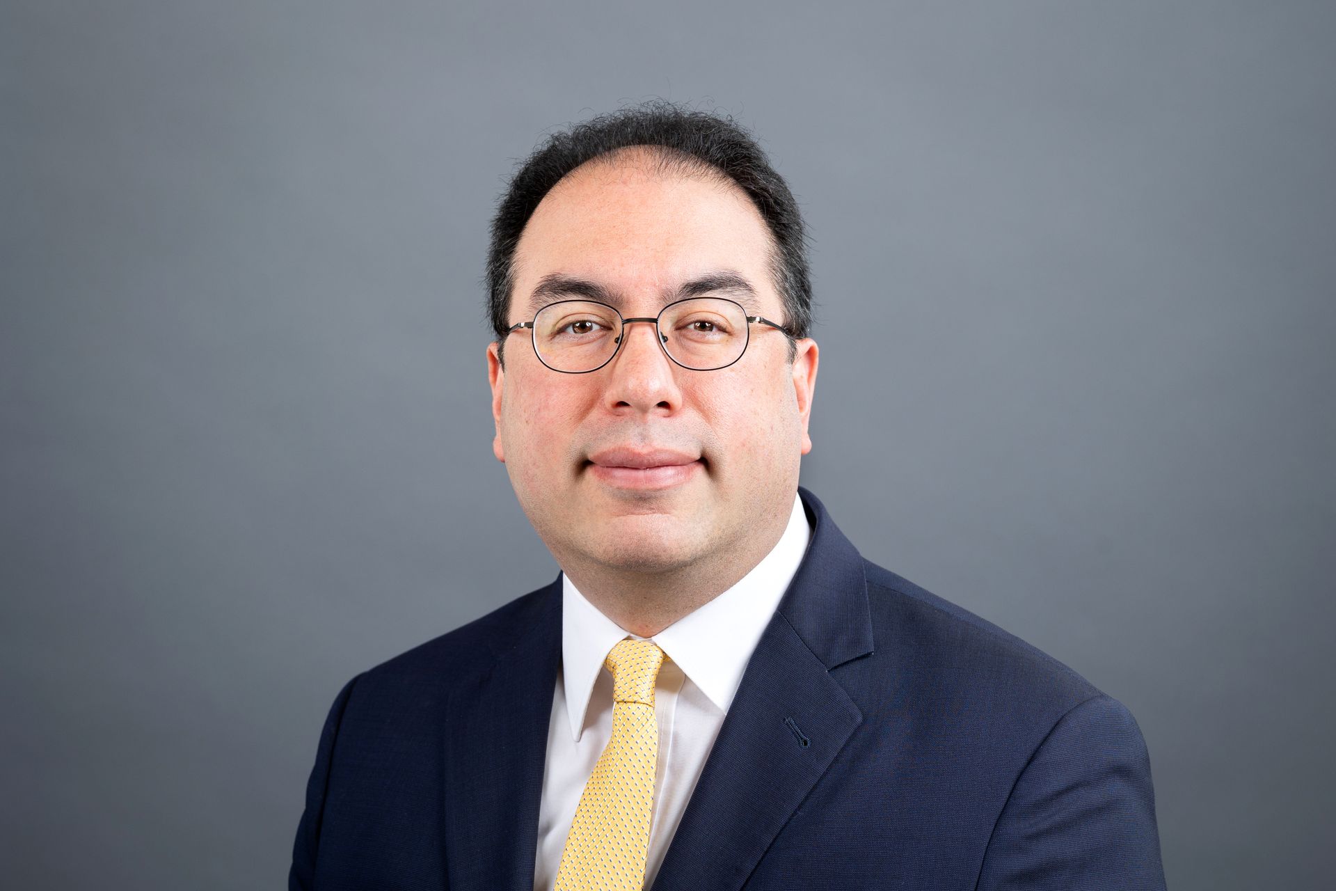 A man in a suit and tie is standing