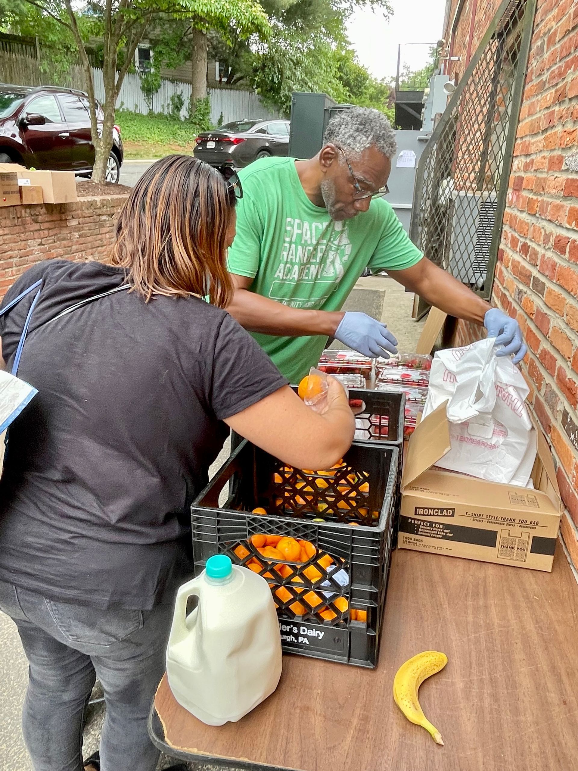 A man and a woman are standing next to each other at a table.