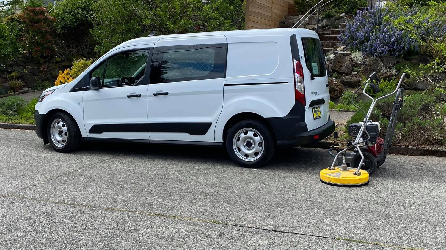 Rojo Moss Removal and Power Washing, LLC work van and pressure washer parked on roadside