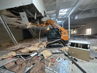 A bulldozer is being used to demolish a building.