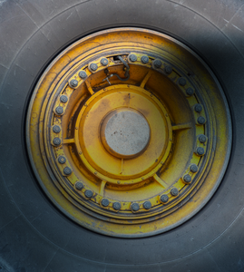 a close up of a yellow wheel with a black tire