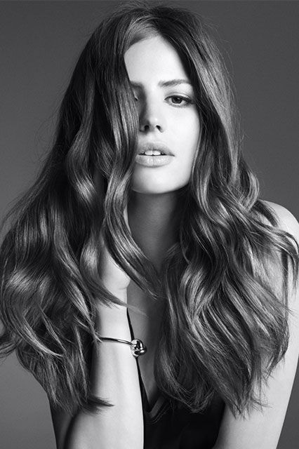 A black and white photo of a woman with long hair.