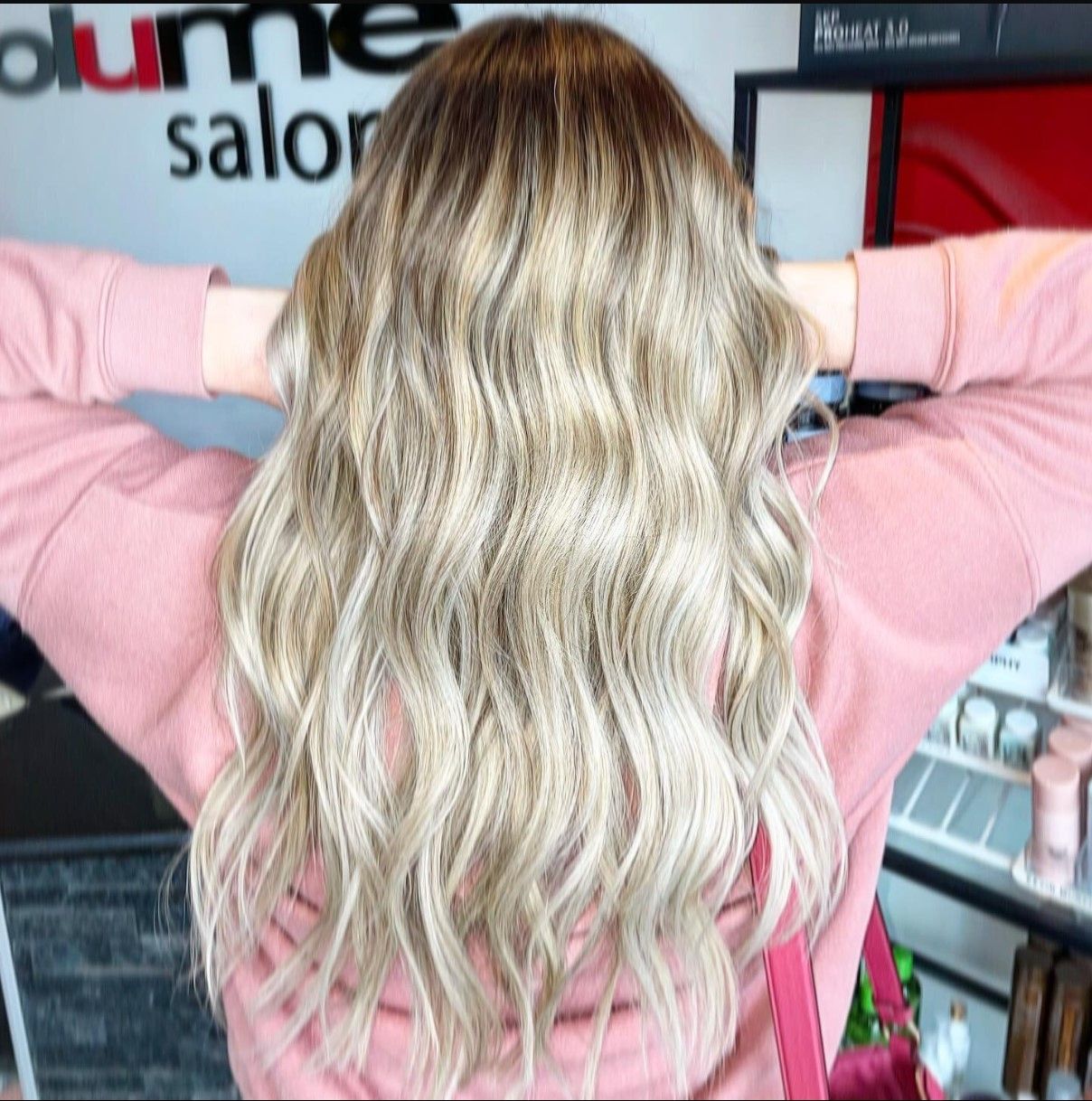 a woman is standing in front of a sign that says plume salon