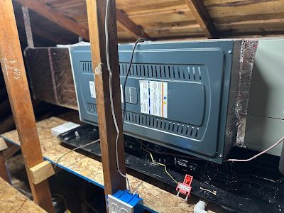 Tip of the Spear HVAC  | an air conditioner is sitting in the attic of a house.