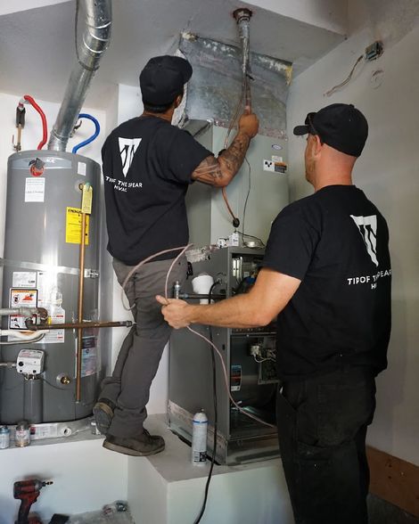 HVAC technicians installing residential furnace and ductwork for heating services in Southern California