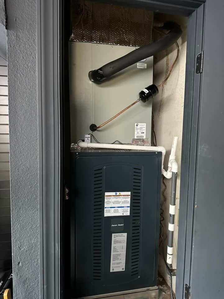 Tip of the Spear HVAC  | an air conditioner is sitting in a closet next to a door.