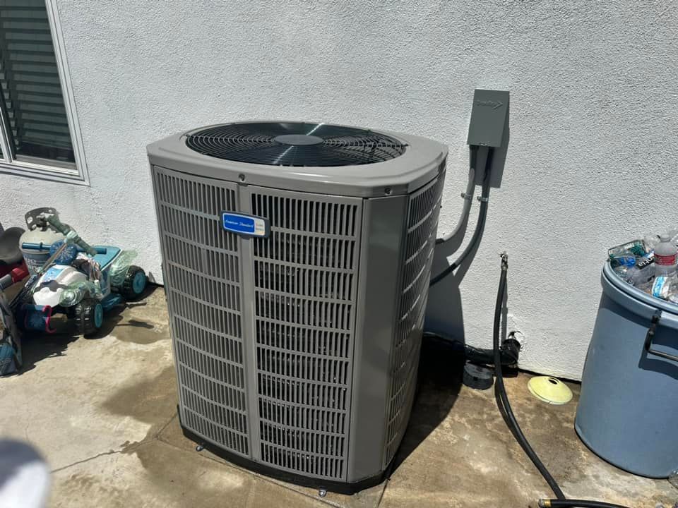 Tip of the Spear HVAC  | a large air conditioner is sitting on the side of a building.