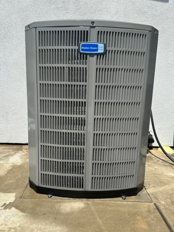 Tip of the Spear HVAC  | a gray air conditioner is sitting on a concrete surface