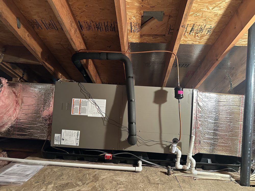 Tip of the Spear HVAC  | an air conditioner is installed in the attic of a house.