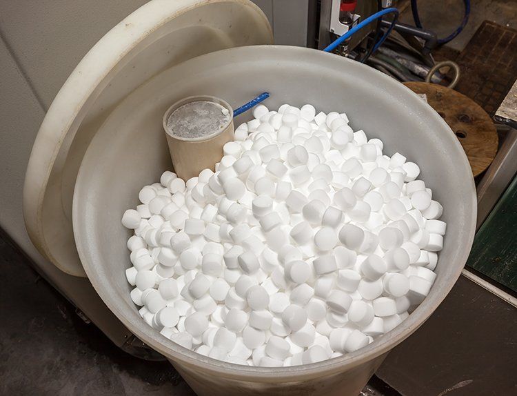 A plastic bucket filled with white foam balls