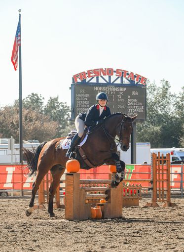 girl going at a jump on horse