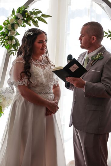 girl smiling at camera with eyes closed 