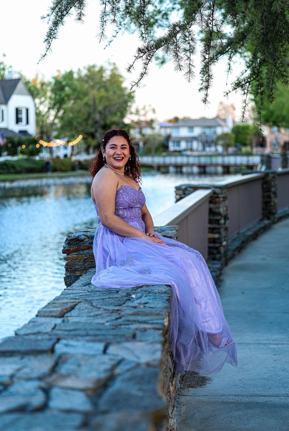 girl in dress next to lake photograph