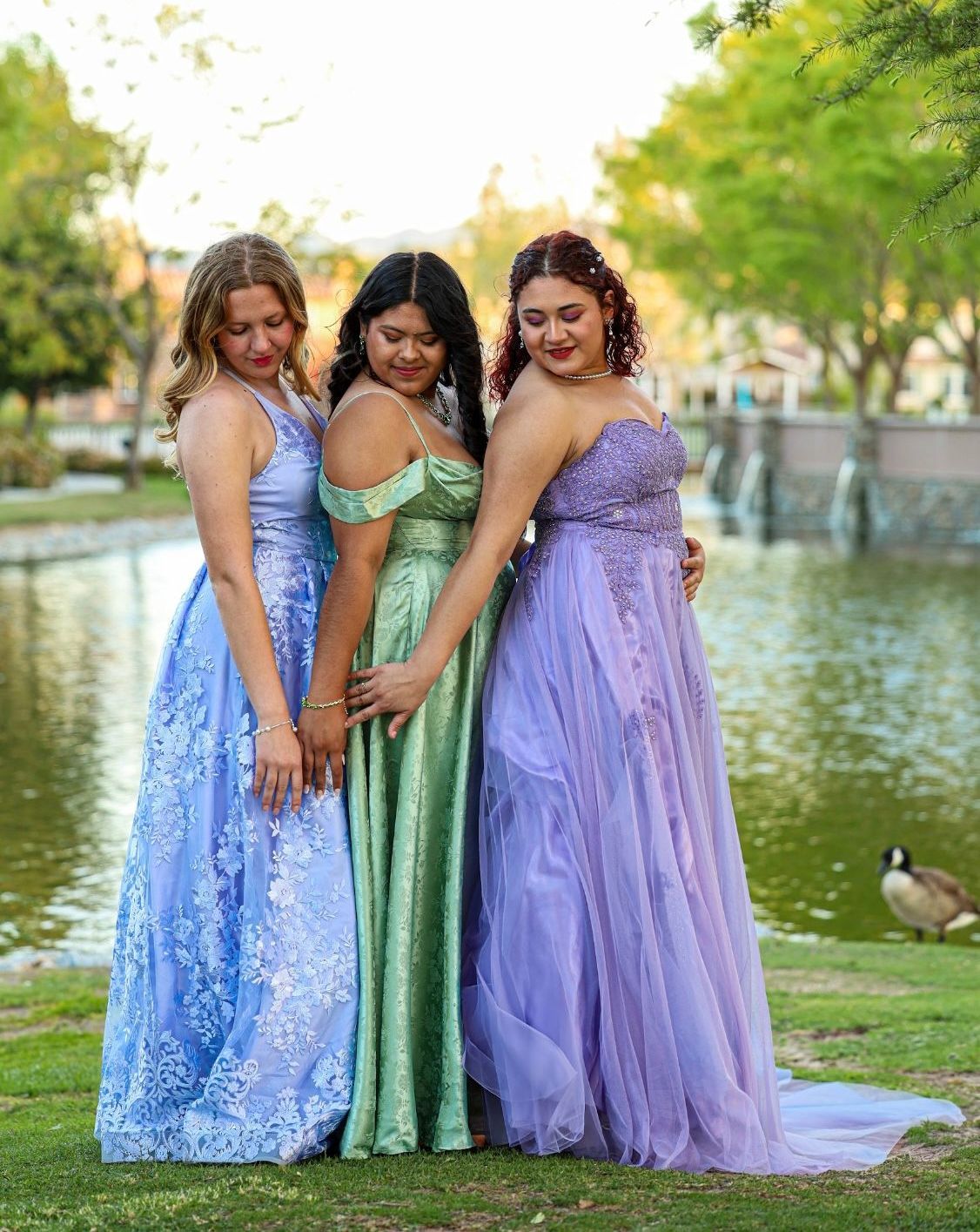 3 girls in dresses near lake
