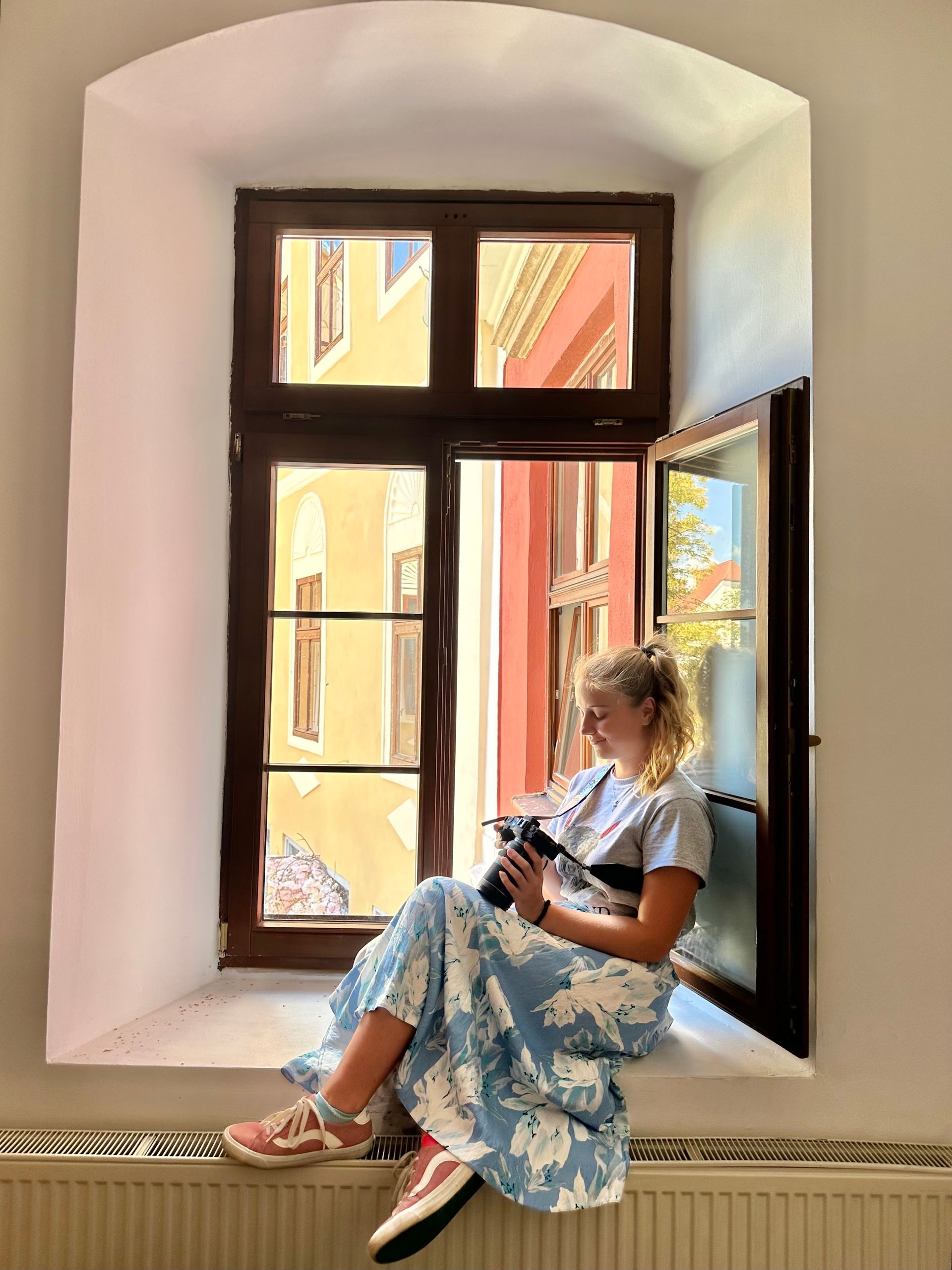 girl next to window looking at camera