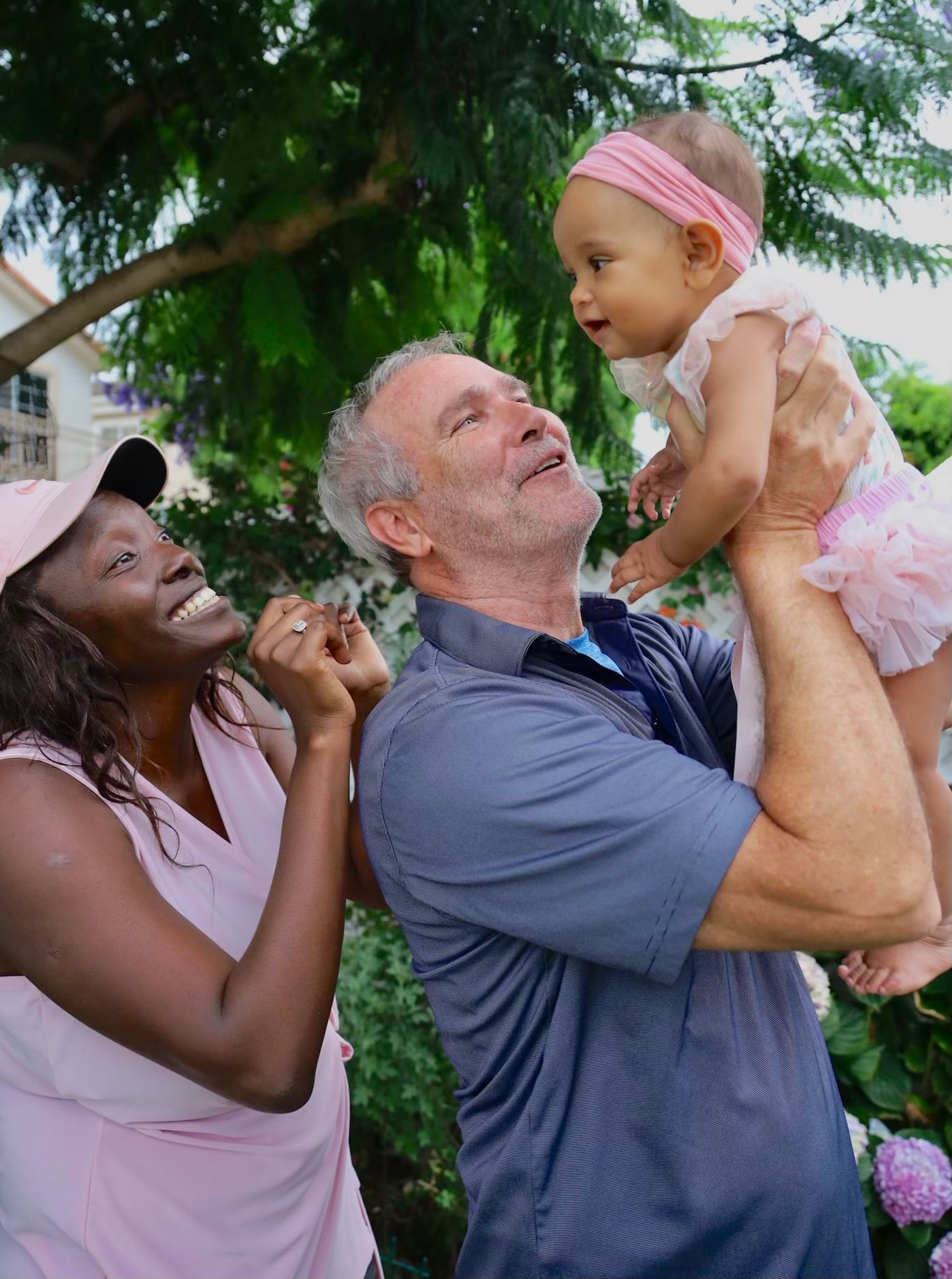 family of 3 holding a baby