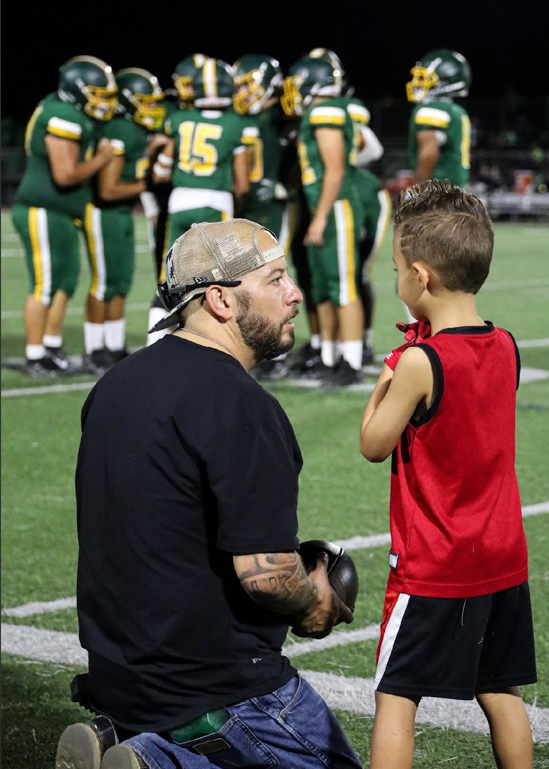 dad and son at football game