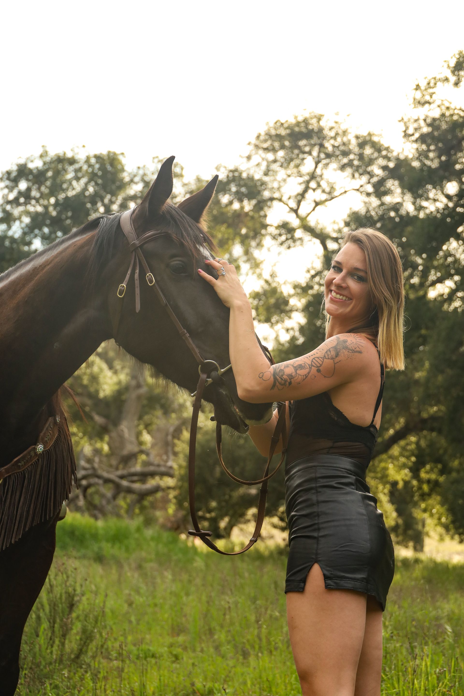girl smiling next to horse