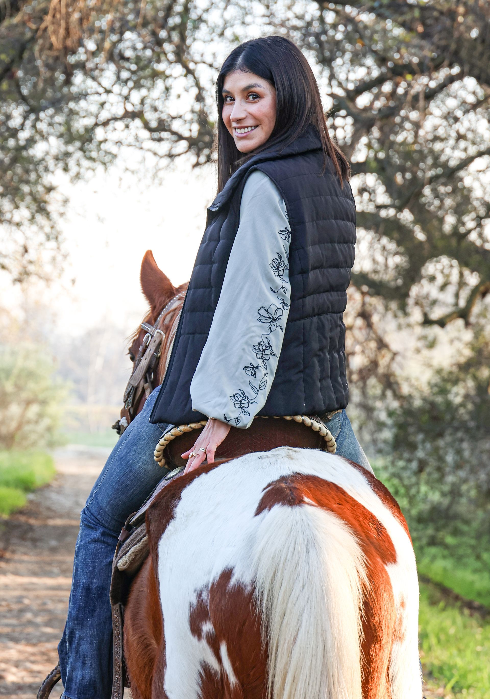 girl smiling while petting horse 