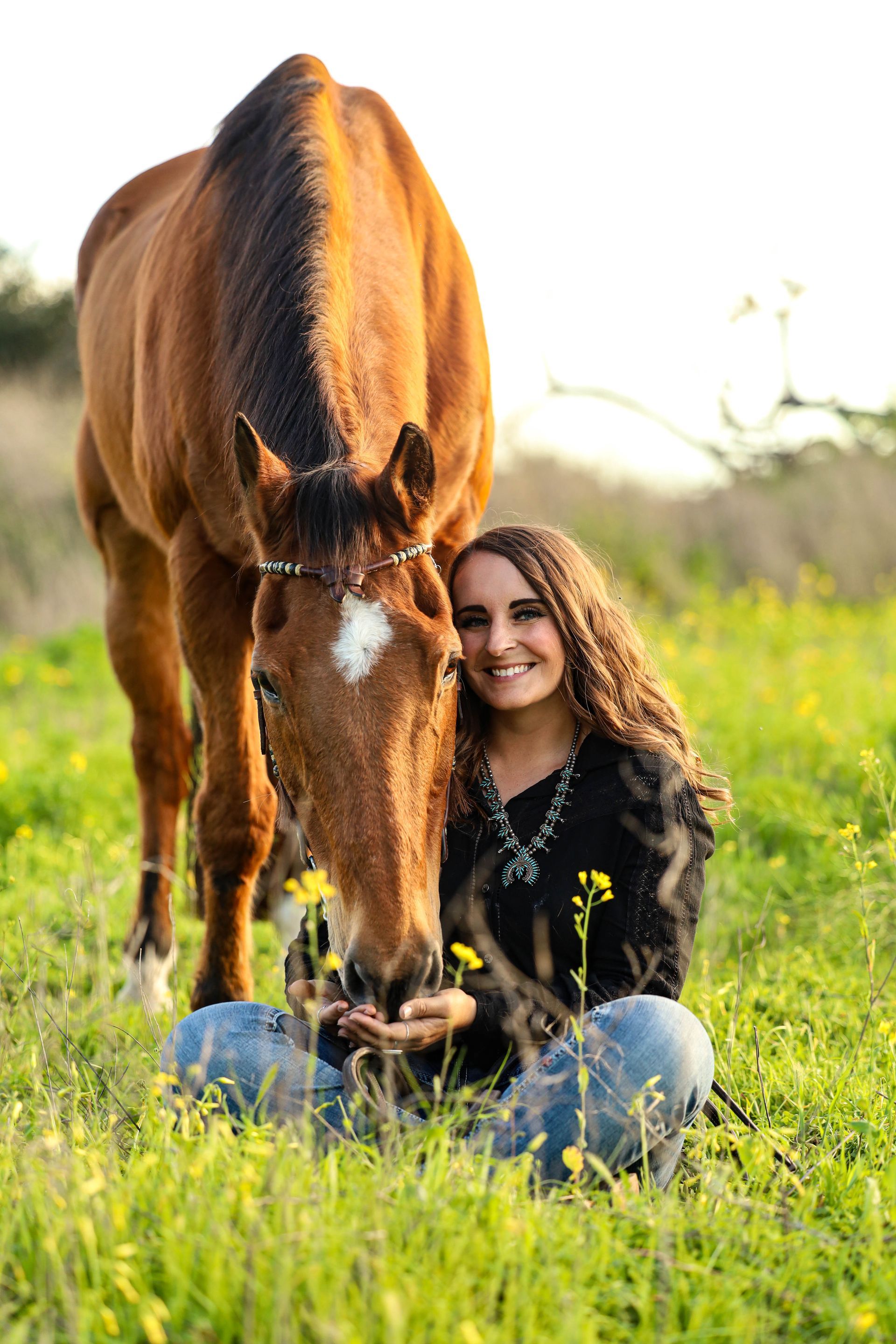 girl smiling next to horse