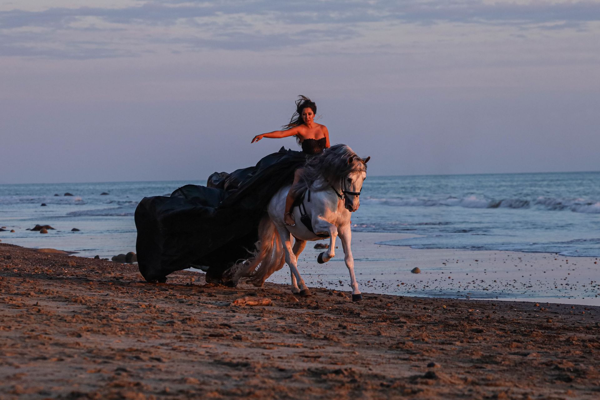 girl riding on beach at sunset