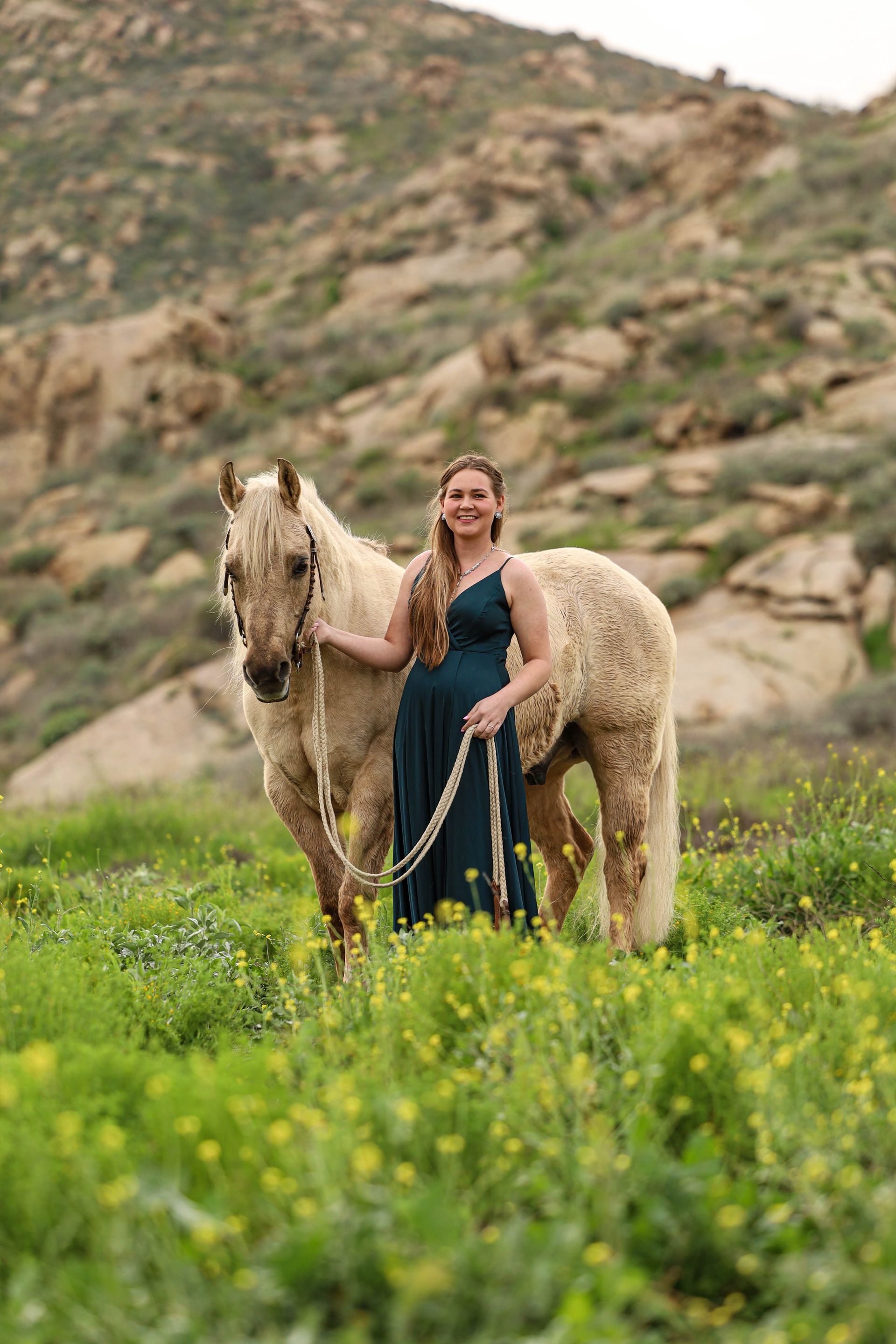 girl smiling next to horse