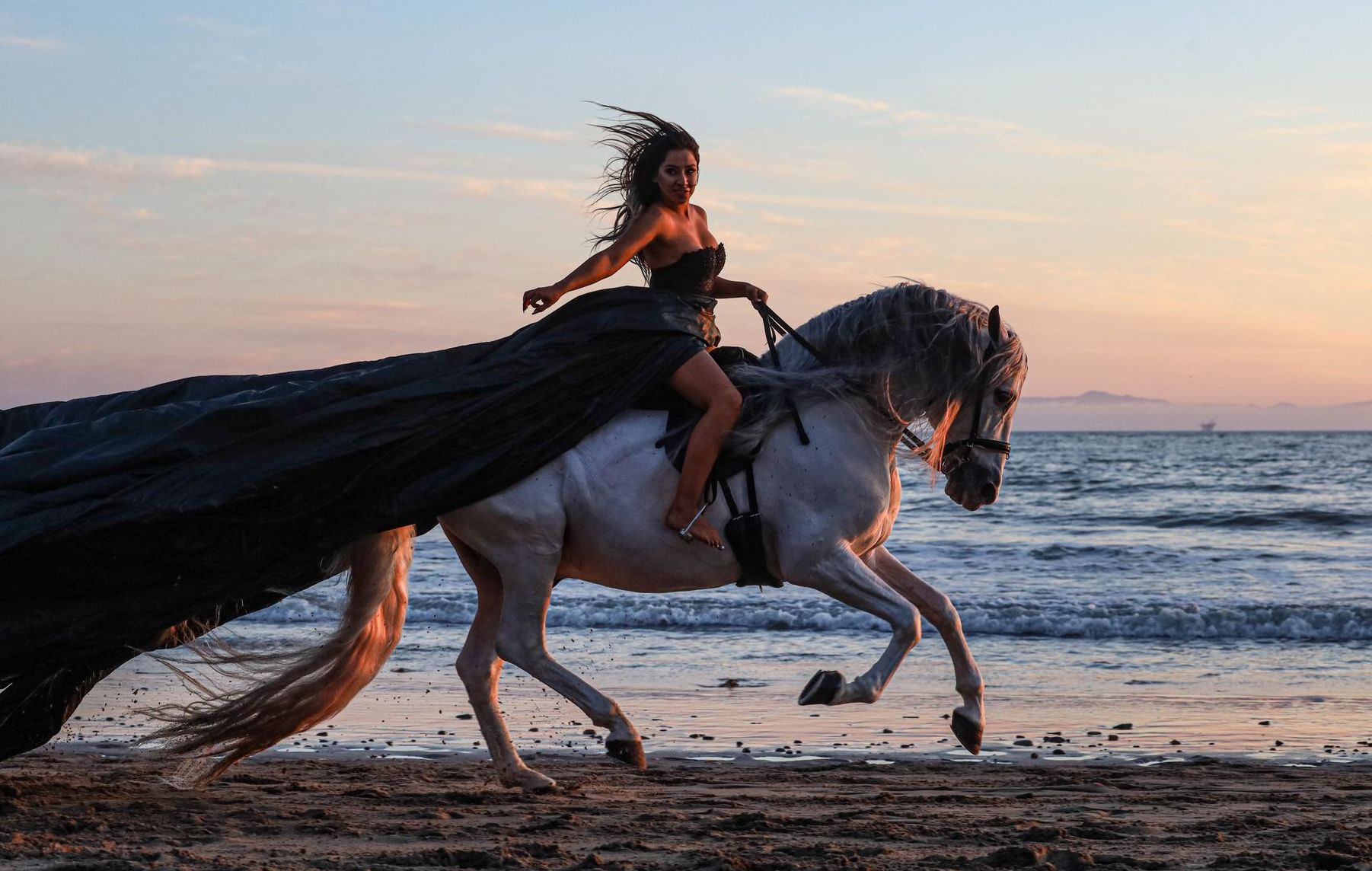girl laying down on horse