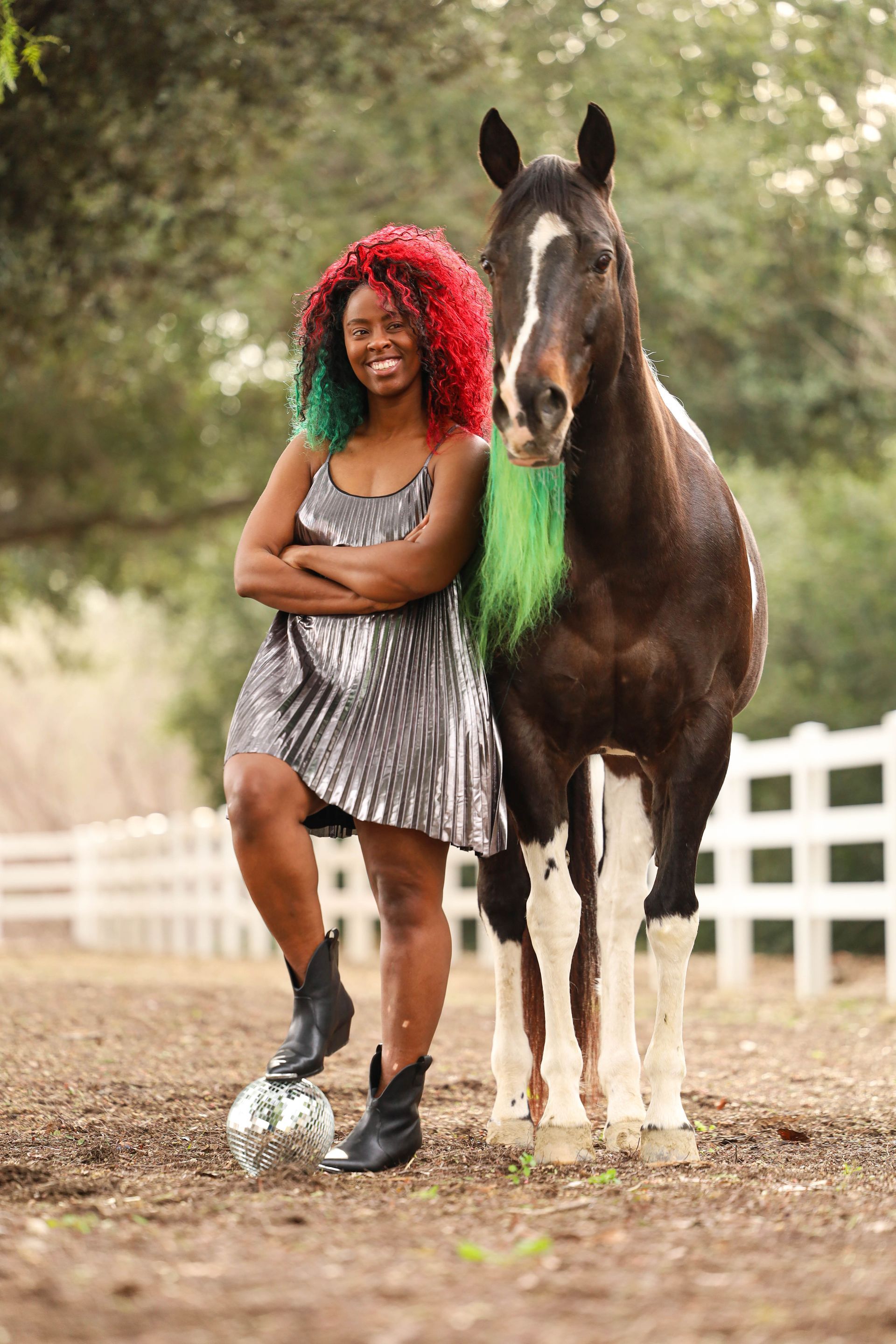 girl smiling while petting horse