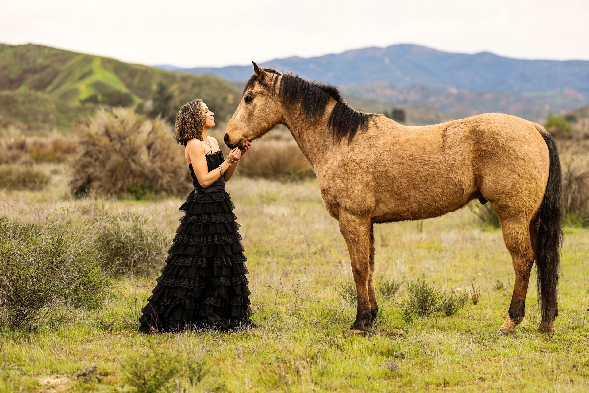 girl holding horses face