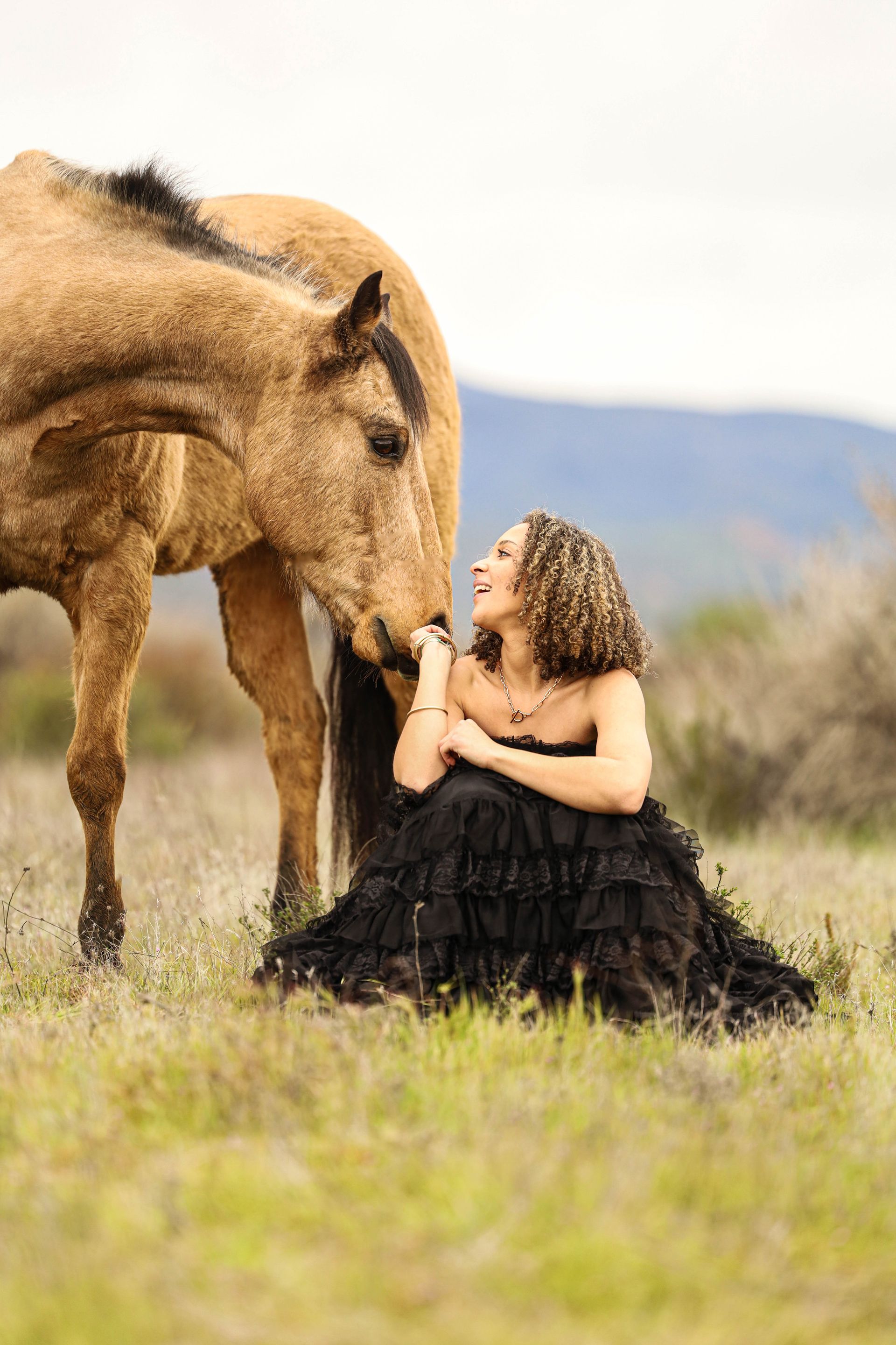 girl smiling up at horse 